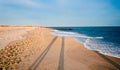 Long evening shadows on the beach at Cape May, New Jersey. Royalty Free Stock Photo