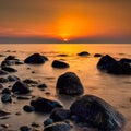 Long exposure of Baltic sea with beach stones during sunset, Dune island, Schonberg, Germany