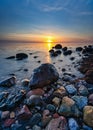 Long exposure of Baltic sea with beach stones during sunset, Dune island, Schonberg, Germany