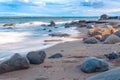 Long Exposure of the Baltic sea landscape. Stones, waves and sunset sun sky. The Gulf of Finland. Summer seascape