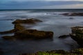 Long exposure of sea water at rocky beach Royalty Free Stock Photo