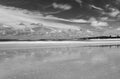 Long Exposure Black and White Beach Scene with Clouds and Reflections Royalty Free Stock Photo
