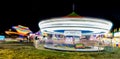 Carousel at a fairground with Tilt-A-Whirl in the background