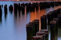 Long exposure at the Brooklyn Bridge Park in New York City across east river with wood pilings water