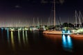 Sailing boats light up the harbour in the night sky with blurry long exposer water Royalty Free Stock Photo