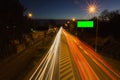 Long exposure car light trail on asphalt road with green screen billboard for advertisment placement. Traffic concept, Ceske Royalty Free Stock Photo