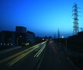 Long exposure of cars passing through of the transmission tower. Royalty Free Stock Photo