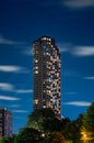 Long exposure of clouds moving across a dark blue sky over a highrise residential building in the Lakeview neighborhood along Lake