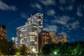 Long exposure of clouds moving across a dark blue sky over modern residential highrise buildings in the Lakeview neighborhood