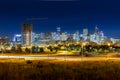 Long Exposure of Denver City Skyline during night with green grass and light trails Royalty Free Stock Photo