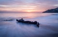 Long exposure of driftwood amazing sunset colors Royalty Free Stock Photo