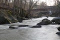 Long exposure of a flowing rocky river in the woods