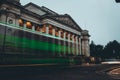 Long exposure of a green bus passing in front of the arhitecture museum in cambridge city Royalty Free Stock Photo