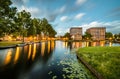 Long exposure of housing buildings and boats along a canal in Amsterdam Royalty Free Stock Photo