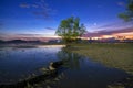 Long exposure image of dramatic sunset or sunrise,sky clouds over mountain with tree in the sea Royalty Free Stock Photo