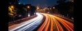 A long-exposure image of light trails from moving vehicles at night, creating a sense of motion and excitement. Web banner