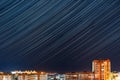 Long exposure image showing star trails over the city. The time-lapse in the night during self-isolation, pandemic Royalty Free Stock Photo