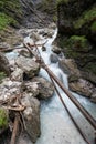 Long exposure image of tree logs lying in beautiful stream of water