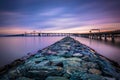 Long exposure of a jetty and the Chesapeake Bay Bridge, from San Royalty Free Stock Photo
