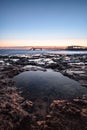 Long exposure of a lava beach. Sandy beach in the morning. Bay, coast, Corralejo, Las Palmas Province, Spain Royalty Free Stock Photo