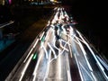 Long exposure light trails on the street at night, motion speed traffic light with blurred traces from cars on road Royalty Free Stock Photo