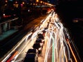 Long exposure light trails on the street at night, motion speed traffic light with blurred traces from cars on road Royalty Free Stock Photo