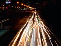 Long exposure light trails on the street at night, motion speed traffic light with blurred traces from cars on road Royalty Free Stock Photo