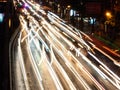 Long exposure light trails on the street at night, motion speed traffic light with blurred traces from cars on road Royalty Free Stock Photo