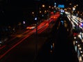 Long exposure light trails on the street at night, motion speed traffic light with blurred traces from cars on road Royalty Free Stock Photo