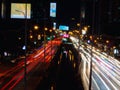 Long exposure light trails on the street at night, motion speed traffic light with blurred traces from cars on road Royalty Free Stock Photo