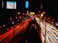 Long exposure light trails on the street at night, motion speed traffic light with blurred traces from cars on road Royalty Free Stock Photo