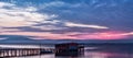 Long exposure of magic sunrise over the ocean with a hut in the