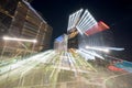 Long exposure night photo fast zoom out effect Downown Miami cityscape and metrorail station