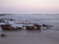 Wet sea rocks at dusk