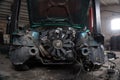 a mechanic disassembles an old dirty car engine on a red lift for repair and tuning turbo car Royalty Free Stock Photo