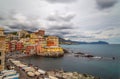 Long exposure photo of Genoa Boccadasse under a cloudy sky, a fishing village and colorful houses in Genoa, Italy.