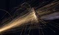 Long exposure photo of hand blocking glowing sparks from an angle grinder