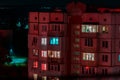 Long exposure photo of high-rise buildings in red and blue lights. Night cityscape. Big city life