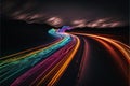 a long exposure photo of a highway with a rainbow of light streaks on it\'s side and a dark sky with clouds Royalty Free Stock Photo