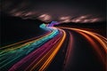 a long exposure photo of a highway with a rainbow of light streaks on it\'s side and a dark sky with clouds Royalty Free Stock Photo