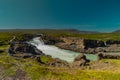 Long exposure photo of magnificent Godafoss waterfall in northern Iceland on a warm summer day. Visible frog from drops of water