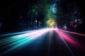 a long exposure photo of a road with trees in the background and light streaks on the road at the end of the line of the road Royalty Free Stock Photo