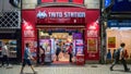 Long exposure photo of Taito station arcade gaming center stands as visitors passes by, Tokyo, Japan