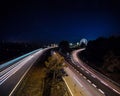 Long exposure photo of traffic on the move at dusk on the motorway and iluminated ferris wheel Royalty Free Stock Photo