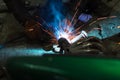 long exposure photo welder performs welding works of metal structures for custom cars