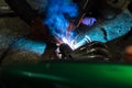 long exposure photo welder performs welding works of metal structures for custom cars