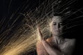 Long exposure photo of woman blocking glowing sparks artistic co Royalty Free Stock Photo