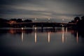 Long exposure photograph of old railway bridge over river at night with reflection in Ratchaburi Thailand Royalty Free Stock Photo