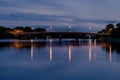 Long exposure photograph of old railway bridge over river at night with reflection in Ratchaburi Thailand Royalty Free Stock Photo