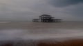 Long exposure photograph of the ruins of West Pier, Brighton Sussex UK on a cold, stormy winter`s day.
